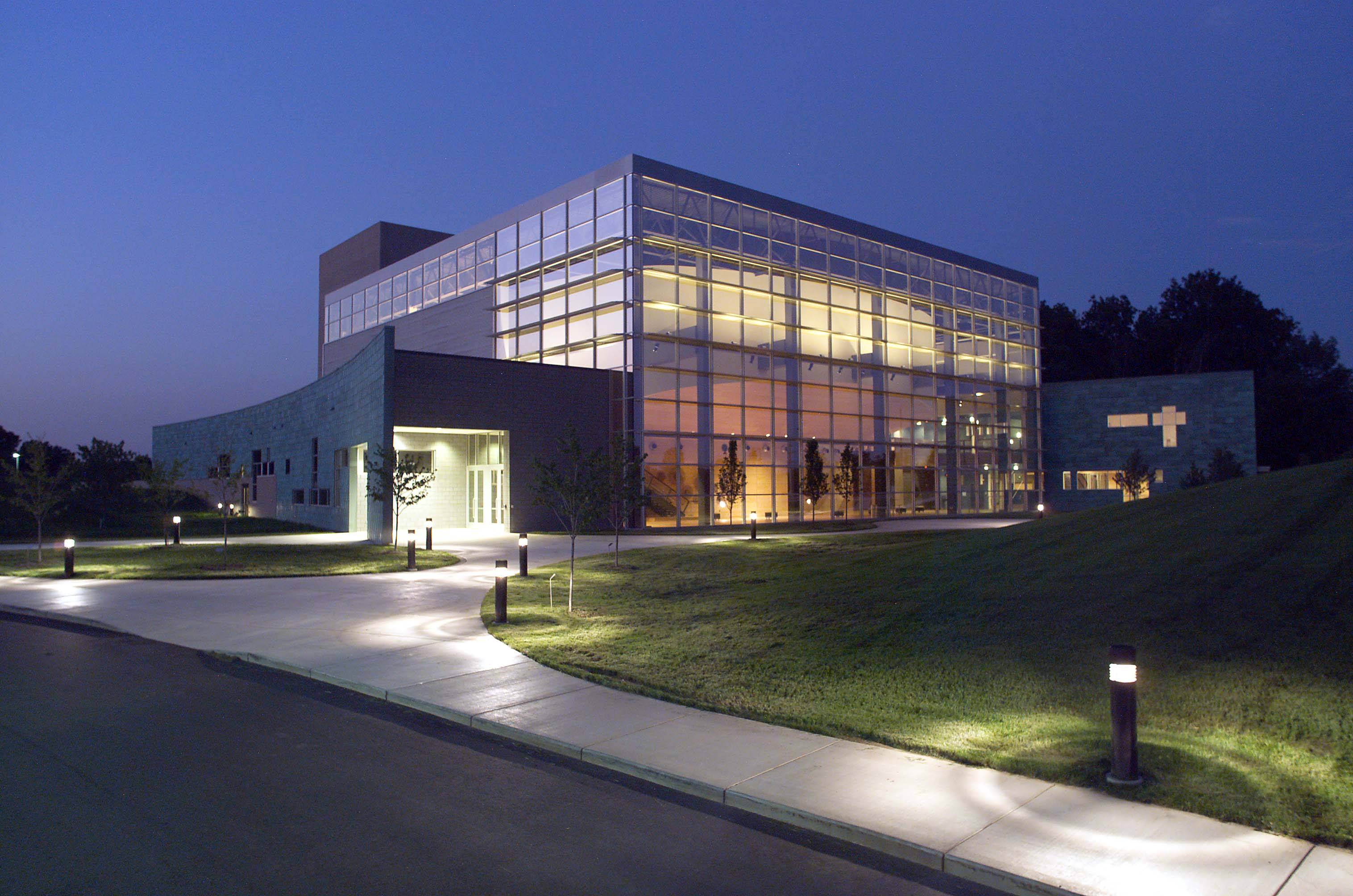 photo of the fine arts center building at night showing the internal lighting features